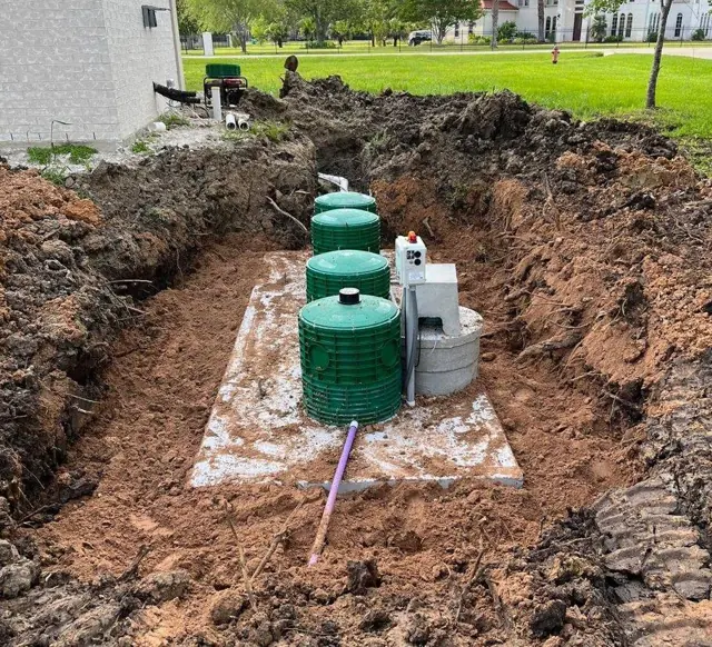 Aerobic septic tank being installed in a trench