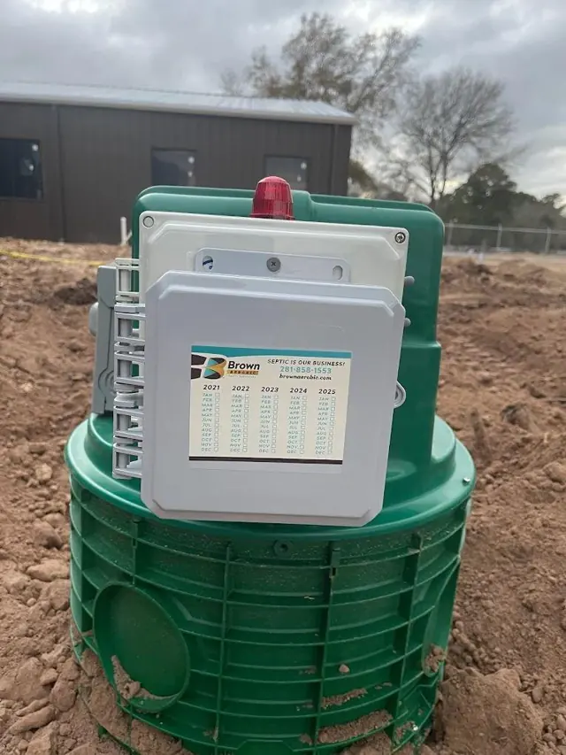 Aerobic septic control panel with alarm light on a green riser