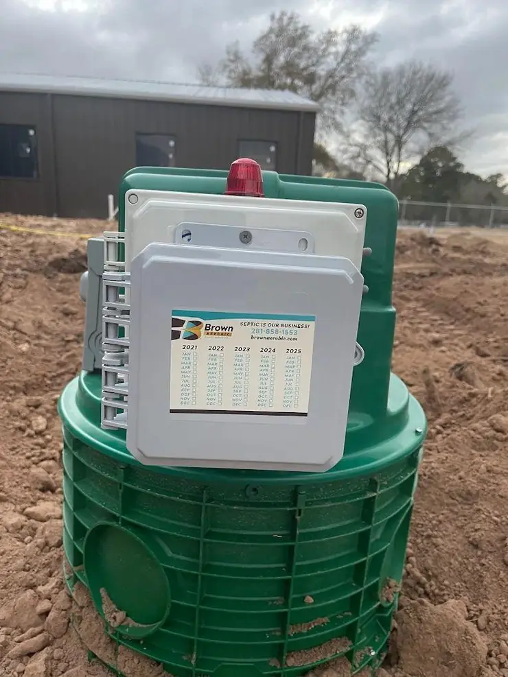 Aerobic septic control panel with alarm light on a green riser (control panel glossary guide)