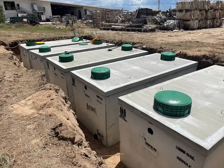 Row of precast septic tanks set in an excavation