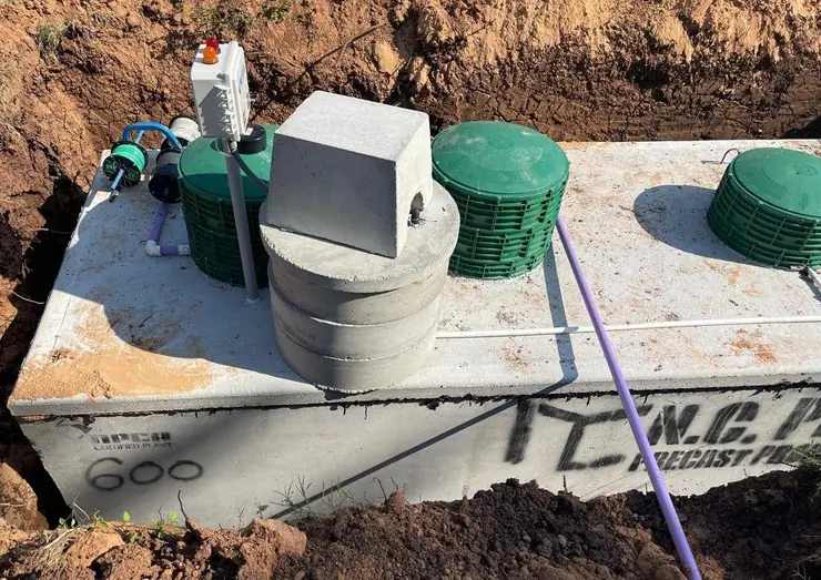 Septic tank with control box and riser lids (high-water alarm glossary guide)