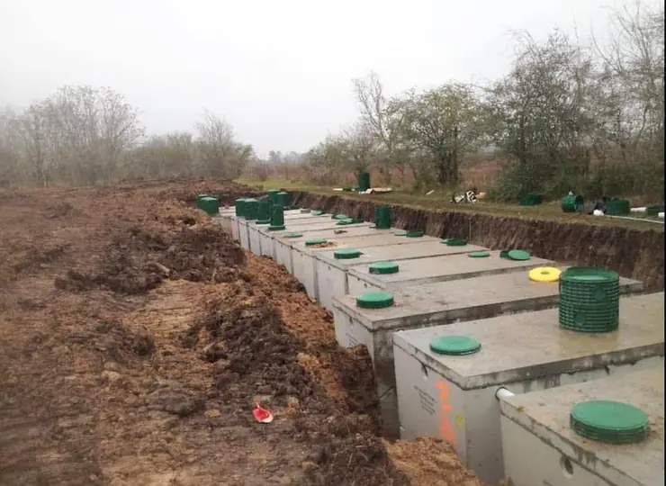 Long row of septic tanks installed in a cleared field near New Caney, TX