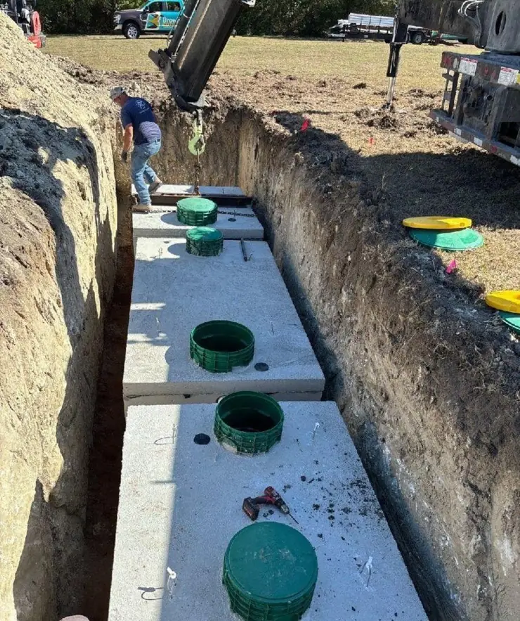 Precast septic tanks lined up in a trench