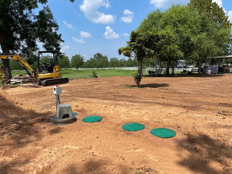 New aerobic septic tank lids and control panel after installation in a residential yard
