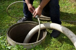 the removal of sewage sludge and cleaning of a domestic septic tank